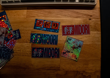 Sticker Pack 01 holographic sticker collection displayed on wooden desk