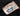 Label with 'Midori Group' branding and a cat illustration on a dark fabric background