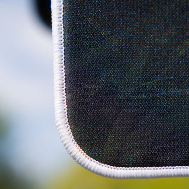Close-up of a uv printed fabric with white trim on a blurred background
