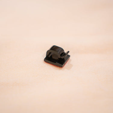 Adhesive desk clamp included with OP1 8K replacement cable for clean cable management